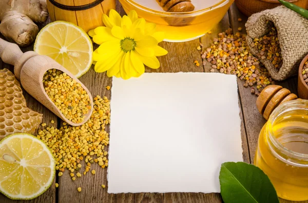 Produtos de apicultura em uma mesa de madeira com cartão vazio para você te — Fotografia de Stock