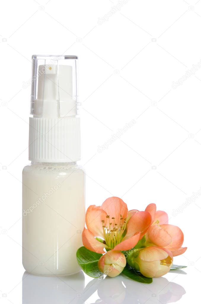 bottle with  lotion and flowers isolated on white