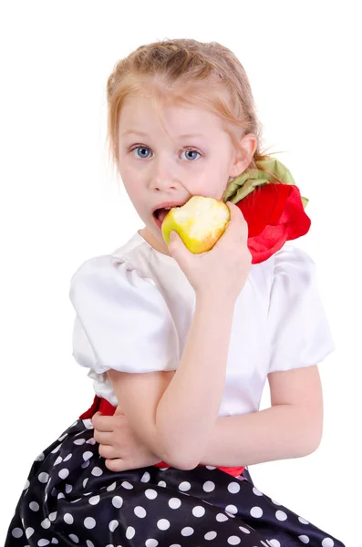 Beautiful young girl eating an apple isolated on white — Stock Photo, Image