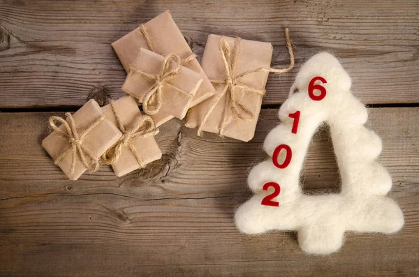 Christmas card with decorations and parcels on wooden board — Stock Photo, Image