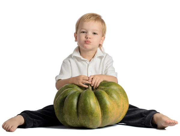 Cute boy sitting with pumpkin isolated on white background — Stock Photo, Image