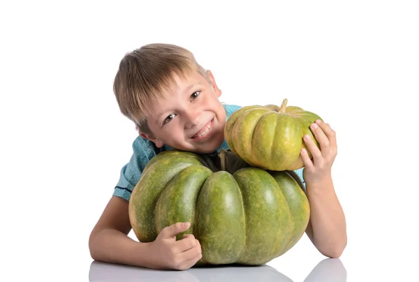 Cute boy sitting with different pumpkins on halloween — Stock Photo, Image