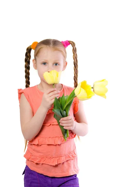 Little girl smelling tulips — Stock Photo, Image