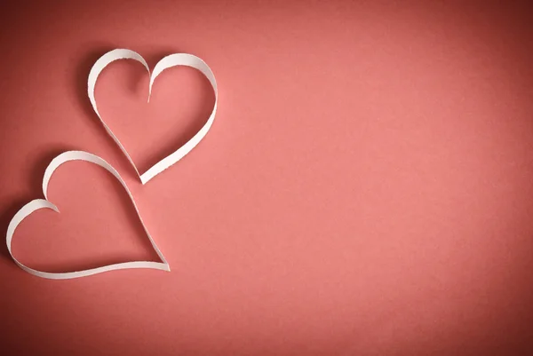 Hearts from white paper lying on a red background — Stock Photo, Image