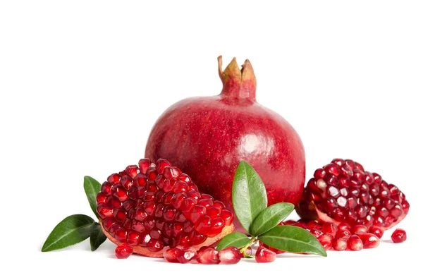 One whole and part of a pomegranate with pomegranate seeds and l — Stock Photo, Image