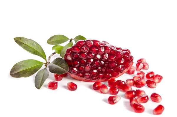 Part of a pomegranate with pomegranate seeds and leaves isolated on white background — Stock Photo, Image