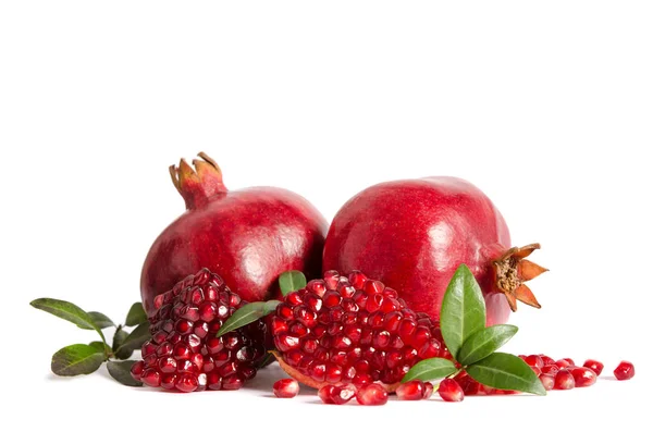 Two whole and part of a pomegranate with pomegranate seeds and l — Stock Photo, Image