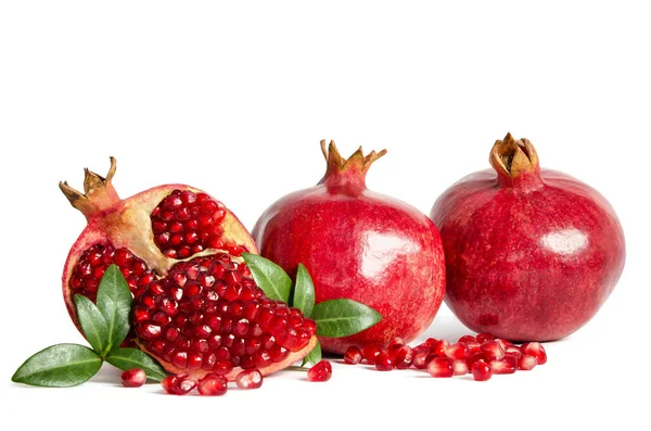 Two whole Pomegranates and two parts of Pomegranate with leaves — Stock Photo, Image