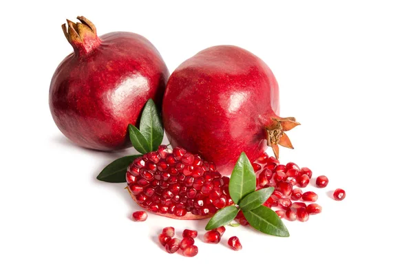 Two whole and part of a pomegranate with pomegranate seeds — Stock Photo, Image