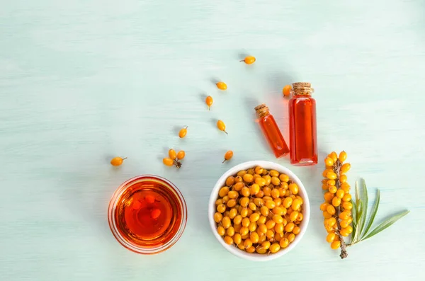 Sea buckthorn and two bottles, bowl  with sea buckthorn oil