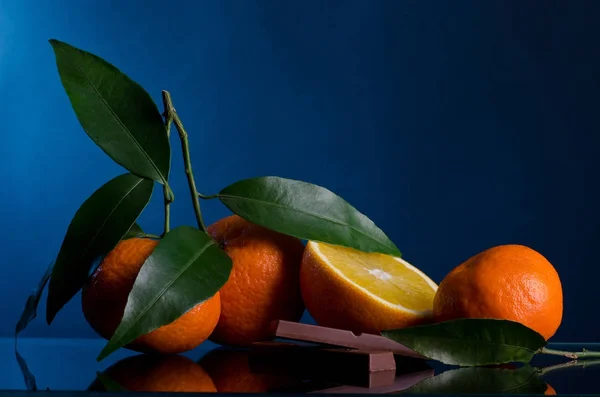 Oranges and Chocolate on dark background — Stock Photo, Image
