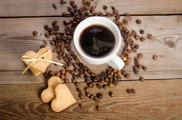 The cup of coffee, coffee beans and cookies-hearts — Stock Photo, Image