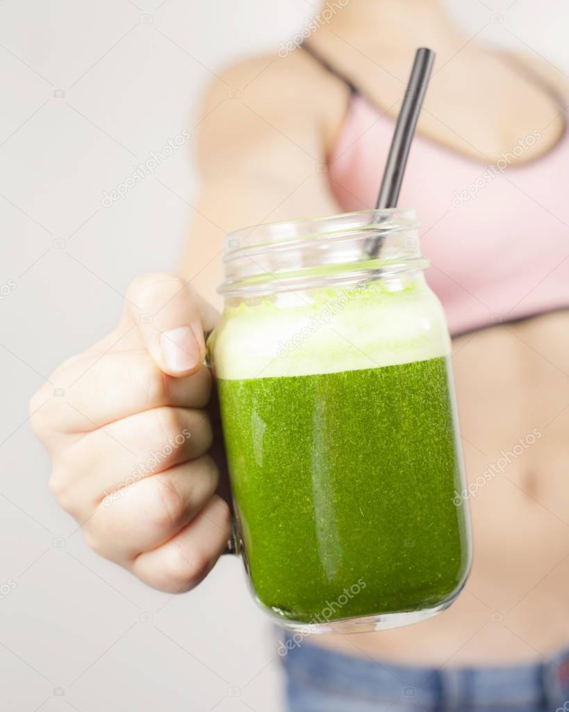 Teenage girl with green smoothie