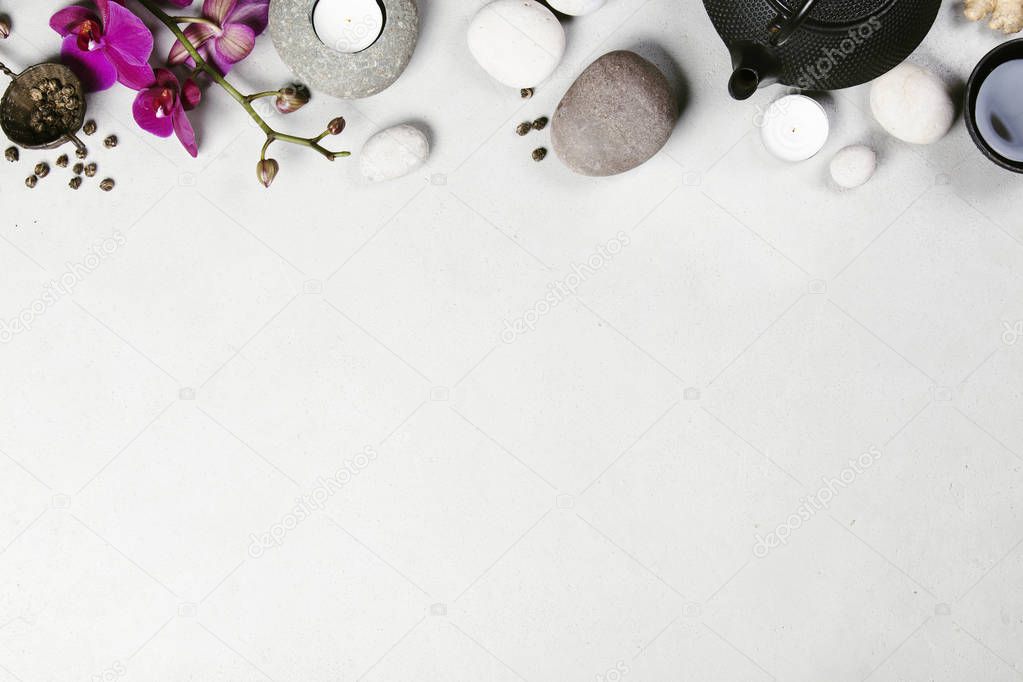 Asian tea set and spa stones on concrete background