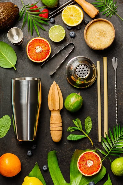 Cocktail making bar tools, shaker, tropical fruits and leaves — Stock Photo, Image
