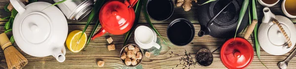 Various tea and teapots composition, dried herbal, green, black tea and matcha tea on wooden table background — Stok fotoğraf