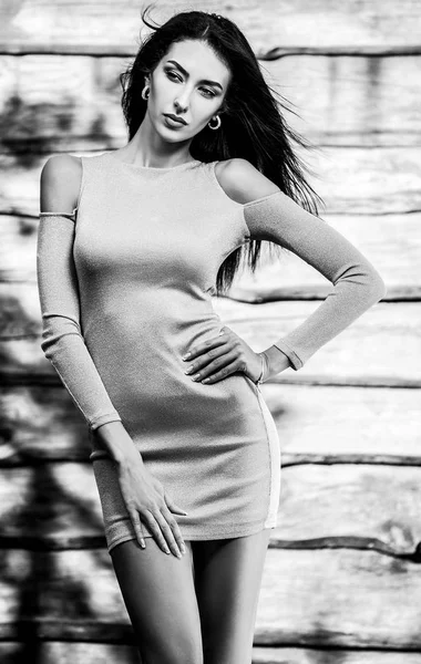 Junge sinnliche und schöne brünette Frau posiert vor hölzernem Hintergrund. Schwarz-Weiß-Foto. — Stockfoto