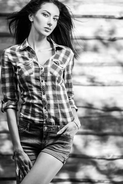 Joven sensual y belleza morena posan sobre fondo de madera. Foto en blanco y negro . — Foto de Stock