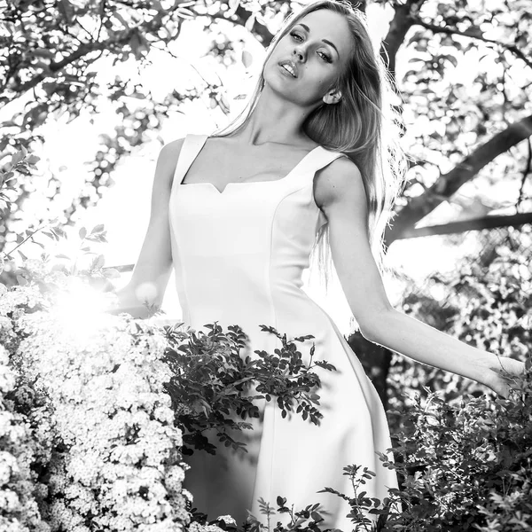 Black-white outdoor portrait of beautiful young sexual blonde woman against nature background. — Stock Photo, Image