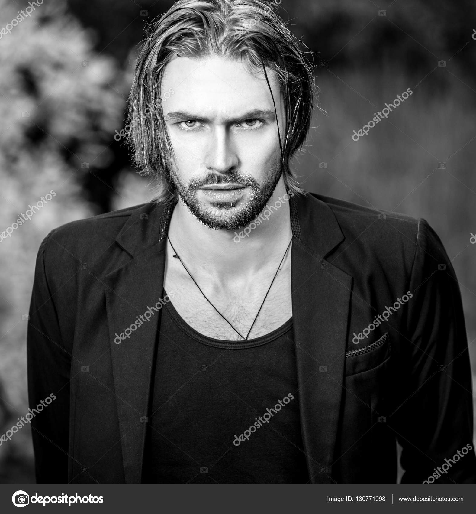 Black-white outdoor portrait of elegant long hair handsome man. Stock Photo  by ©innervision 130771098