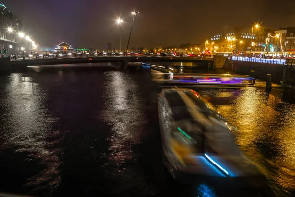 Amsterdam, Nederländerna - 02 januari 2017: Kryssning båt i natt kanalerna i Amsterdam. 02 januari 2017 i Amsterdam - Nederländerna. — Stockfoto