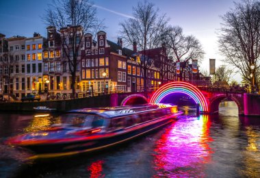 Amsterdam, Hollanda - 10 Ocak 2017: Cruise tekneler acele gece kanallarında. Amsterdam içinde ışık Festivali ışık teçhizatları gece Kanallar üzerinde. 10 Ocak 2017 yılında Amsterdam - Hollanda.
