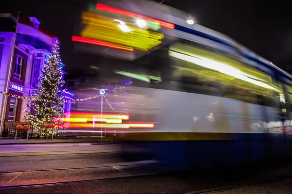 AMSTERDAM, NETHERLANDS - JANUARY 09, 2017: Blurred silhouette of moving tram in Amsterdam city at night. January 09, 2017 in Amsterdam - Netherland. — Stock Photo, Image