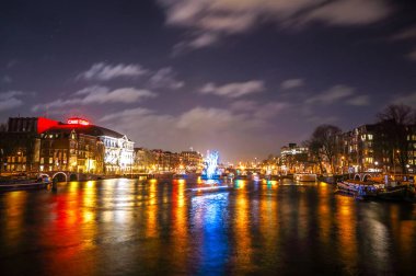 Amsterdam, Hollanda - 12 Ocak 2017: Cruise tekneler acele gece kanallarında. Amsterdam içinde ışık Festivali ışık teçhizatları gece Kanallar üzerinde. 12 Ocak 2017 yılında Amsterdam - Hollanda