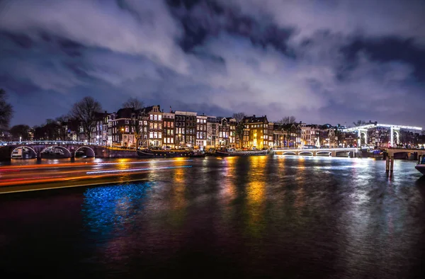 암스테르담, 네덜란드-1 월 12 일, 2017: 아름 다운 밤 도시 운하 암스테르담의 잔해 보트를 이동. 암스테르담-네덜란드에서에서 2017 년 1 월 12 일. — 스톡 사진