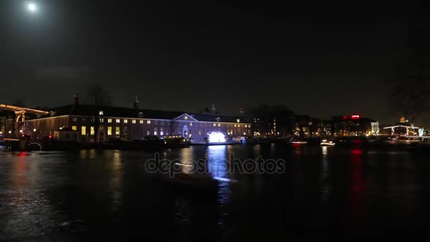 AMSTERDÃO, PAÍSES BAIXOS - JANEIRO 06, 2017: Barcos de cruzeiro correm em canais noturnos da cidade de Amsterdã. Time Lapse. 06 de janeiro de 2017 em Amsterdam - Países Baixos . — Vídeo de Stock