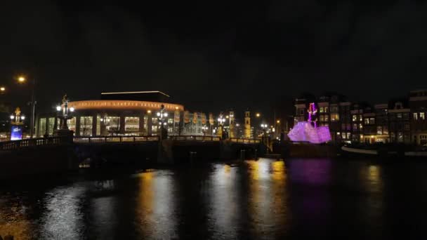 АМСТЕРДАМ, НИДЕРЛАНДЫ - 06 ЯНВАРЯ 2017 года: Круизные лодки мчатся по ночным каналам Амстердама. Время покажет. Январь 06, 2017 в Амстердаме - Нидерланды . — стоковое видео