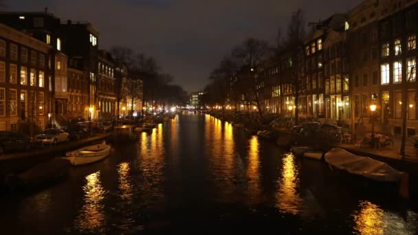 AMSTERDÃO, PAÍSES BAIXOS - JANEIRO 06, 2017: Barcos de cruzeiro correm em canais noturnos da cidade de Amsterdã. Time Lapse. 06 de janeiro de 2017 em Amsterdam - Países Baixos . — Vídeo de Stock