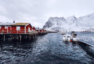 Fishing vessel at the pier of traditional fishing settlements of Lofoten islands. Beautiful Norway landscape. clipart