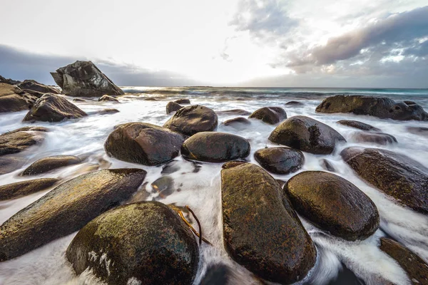 Antiguas piedras en las orillas del frío Mar de Noruega a la hora de la tarde. Islas Lofoten. Hermoso paisaje de Noruega . — Foto de Stock