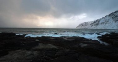 Akşam zaman soğuk Norveç Denizi kıyısında antik taşlar. Lofoten Adaları. Güzel Norveç manzara. HD ayak.