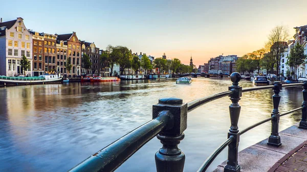 A leg--bb híres csatornák és töltések Amszterdam város naplemente alatt. Általános nézet, és a hagyományos holland építészet. — Stock Fotó