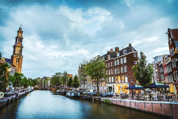 A leg--bb híres csatornák és töltések Amszterdam város naplemente alatt. Általános nézet, és a hagyományos holland építészet. — Stock Fotó