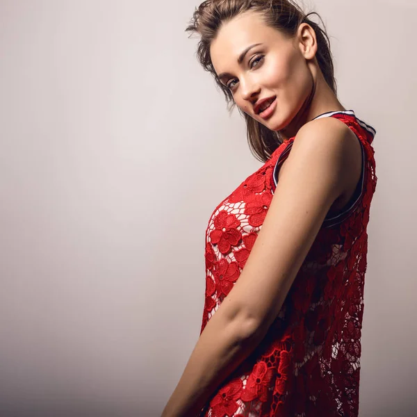Young sensual model woman in red pose in studio. — Stock Photo, Image