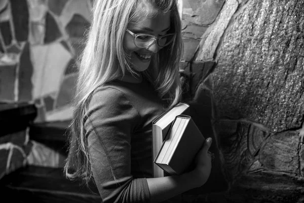 Young beauty woman with books against house interior. — Stock Photo, Image