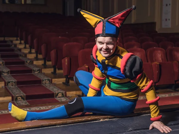 Actor dressed jester's costume in interior of old theater. — Stock Photo, Image