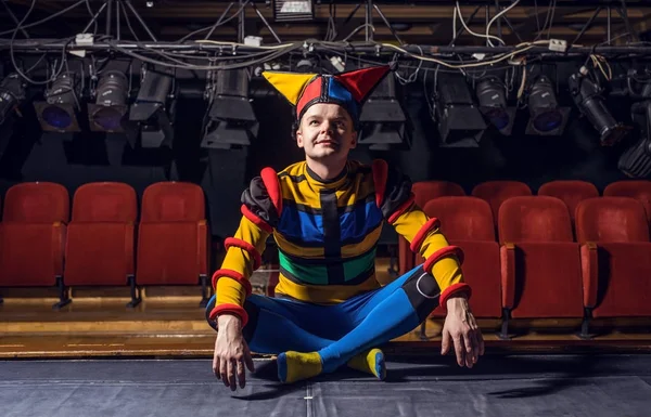 Actor dressed jester's costume in interior of old theater. — Stock Photo, Image