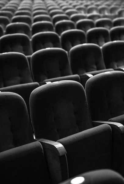 Armchairs of old theater as conceptual background. Black-white photo.