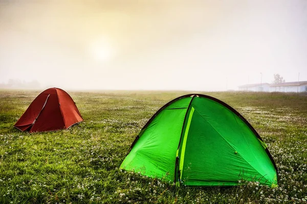Travel tents on the morning field.
