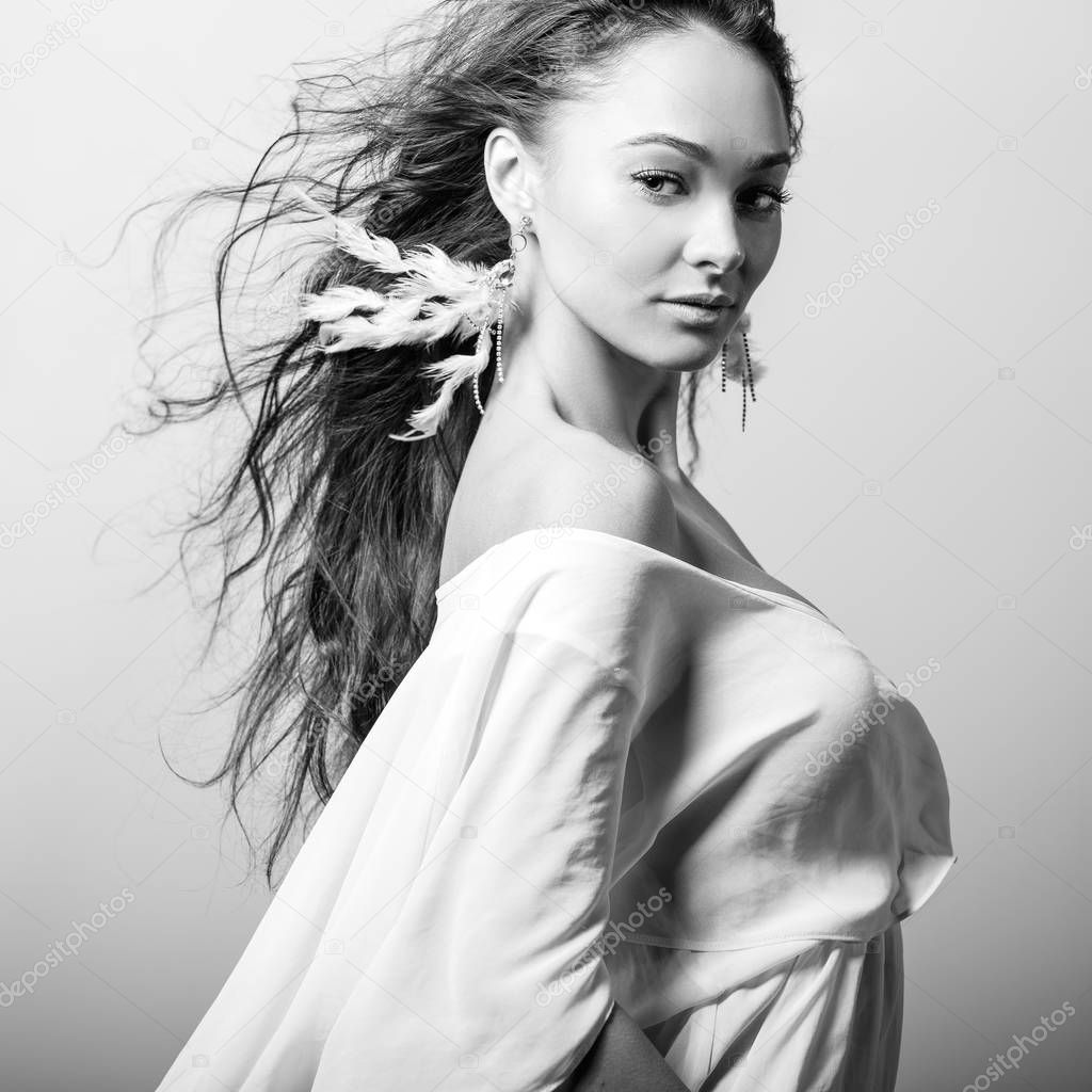 Young beautifull woman pose in studio. Black-white photo.