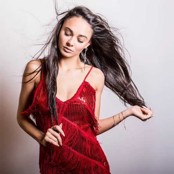 Young sensual woman in red dress pose in studio. — Stock Photo, Image