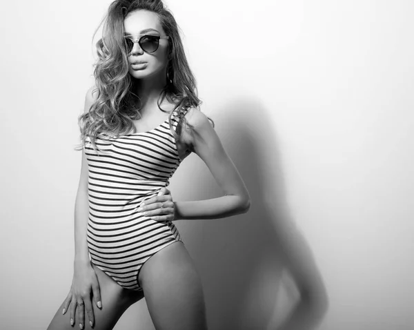 Young beautifull woman in striped swimsuit black-white studio portrait. — Stock Photo, Image