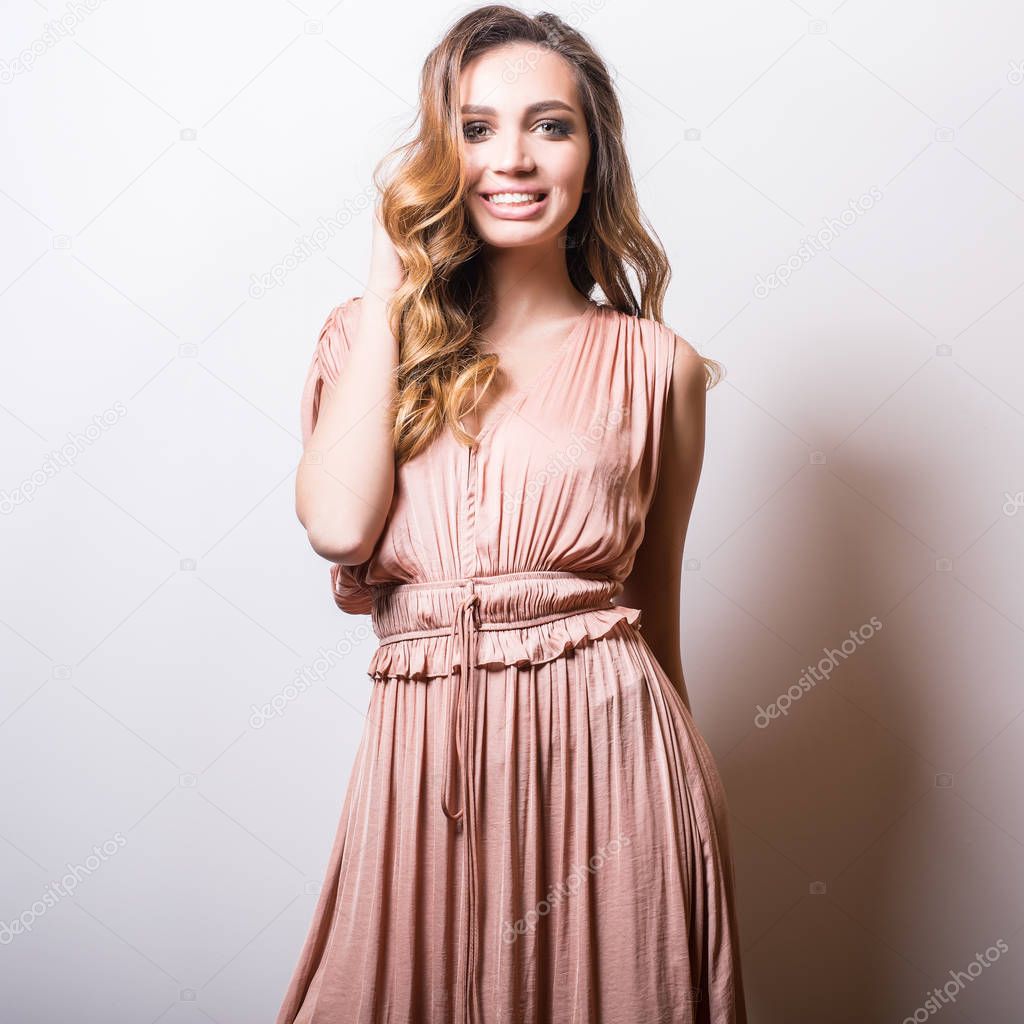 Young beautifull woman in silk dress studio portrait.