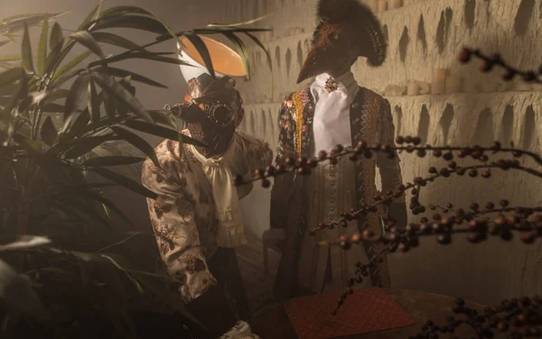 Actors in Steam punk masks and antique costumes indoor.