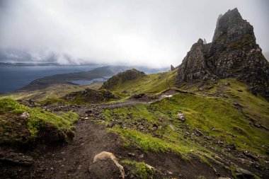Old Man of Storr on the Isle of Skye in Scotland. Mountain landscape with foggy clouds. clipart