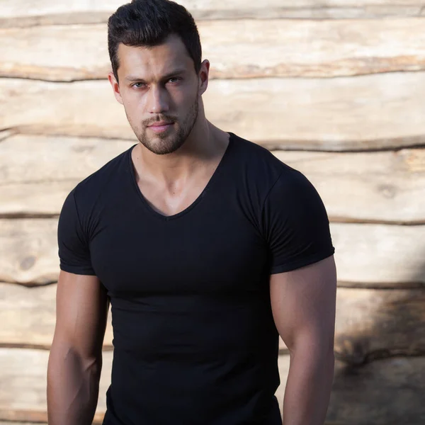 Portrait of handsome young man on wooden background. — Stock Photo, Image